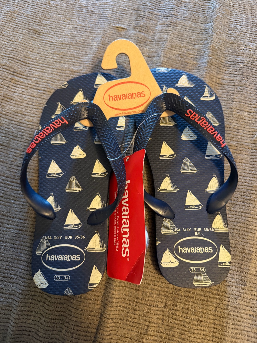 Havaianas Navy Blue Flip Flops with White Sailboat Print and Red Logo